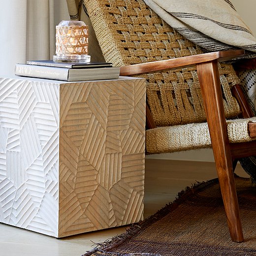 Geometric motifs carved in mango wood give Beth’s Marsh end table a bounty of texture and visual interest.
